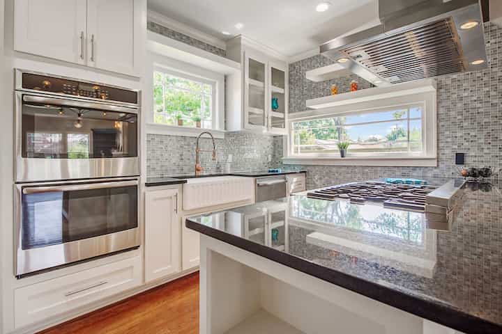 An image of a modern kitchen with sleek appliances, featuring a gas stove, refrigerator, and built-in microwave in University Park